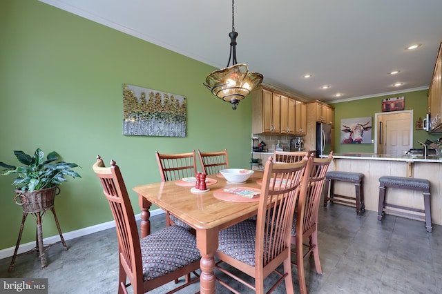 dining space featuring ornamental molding and a chandelier