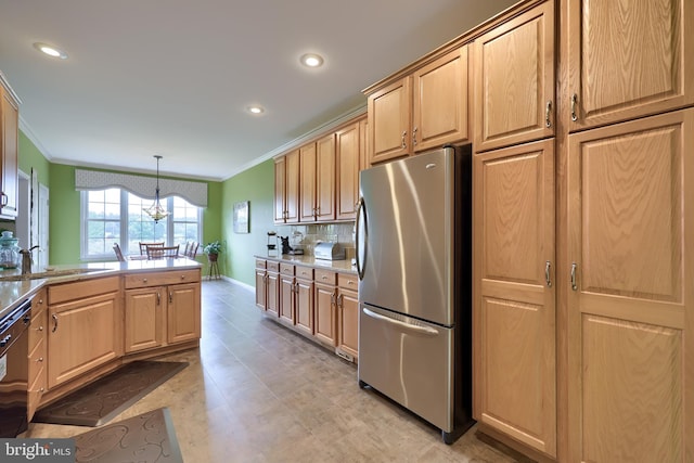 kitchen with sink, stainless steel fridge, crown molding, a chandelier, and decorative light fixtures