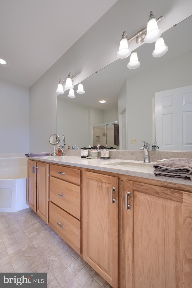 bathroom featuring shower with separate bathtub and vanity