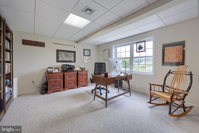 home office featuring light carpet and a paneled ceiling