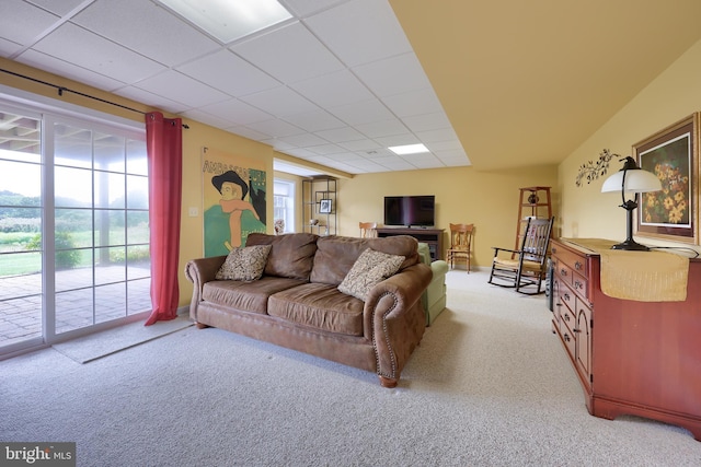 living room featuring light colored carpet and a drop ceiling