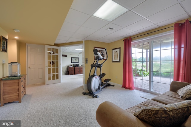 workout room featuring light carpet, french doors, and a paneled ceiling