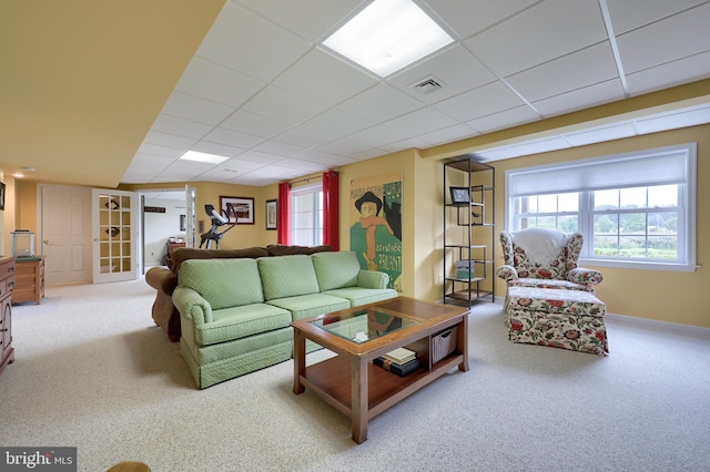 living room with light carpet and a paneled ceiling