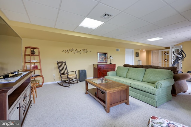 carpeted living room featuring a paneled ceiling