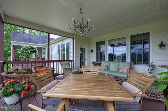 sunroom featuring a chandelier