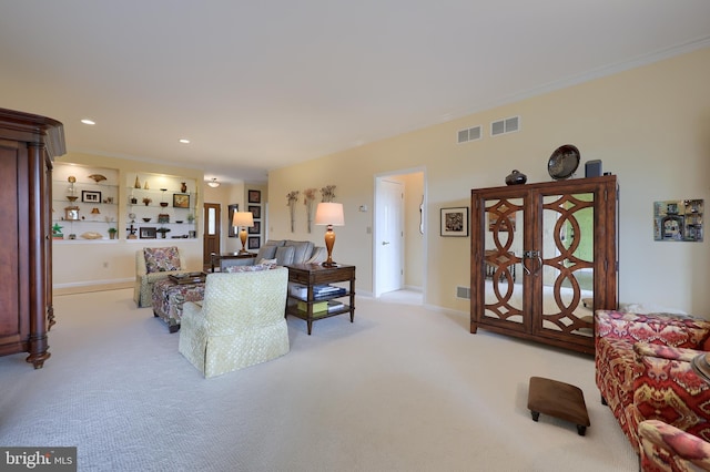 living room featuring light colored carpet, built in features, and crown molding