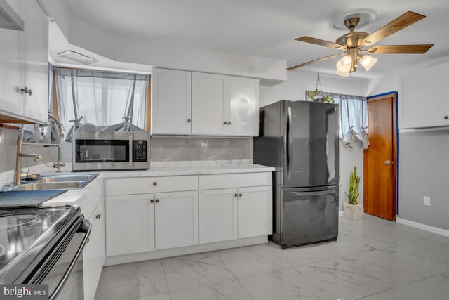 kitchen with black appliances, sink, decorative backsplash, ceiling fan, and white cabinetry