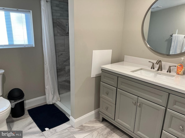 bathroom with walk in shower, vanity, and toilet