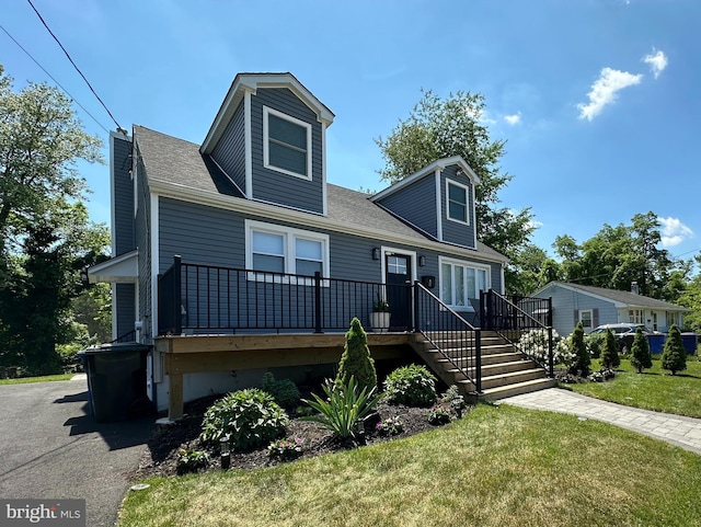 cape cod-style house with a front lawn