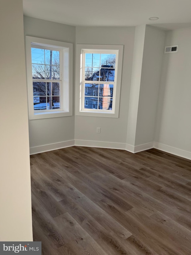 unfurnished room featuring dark hardwood / wood-style flooring