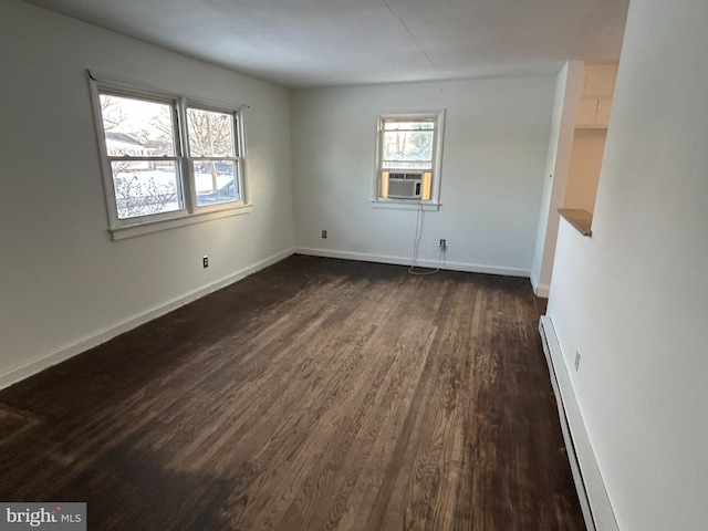 unfurnished room with a baseboard radiator, cooling unit, and dark wood-type flooring