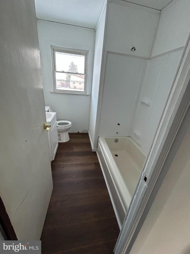 bathroom featuring a tub, toilet, vanity, and hardwood / wood-style flooring