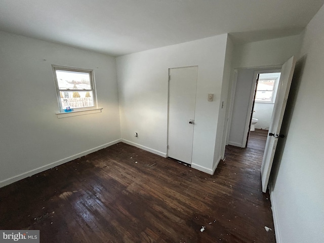 unfurnished bedroom featuring dark hardwood / wood-style flooring