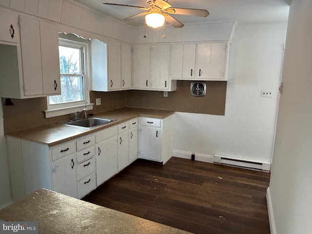 kitchen with sink, white cabinets, a baseboard radiator, and dark hardwood / wood-style floors