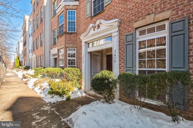 view of snow covered property entrance