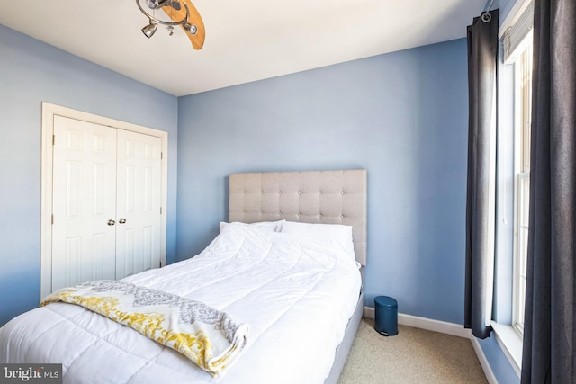 bedroom with light carpet and a closet