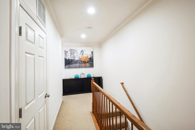 corridor with crown molding and light carpet