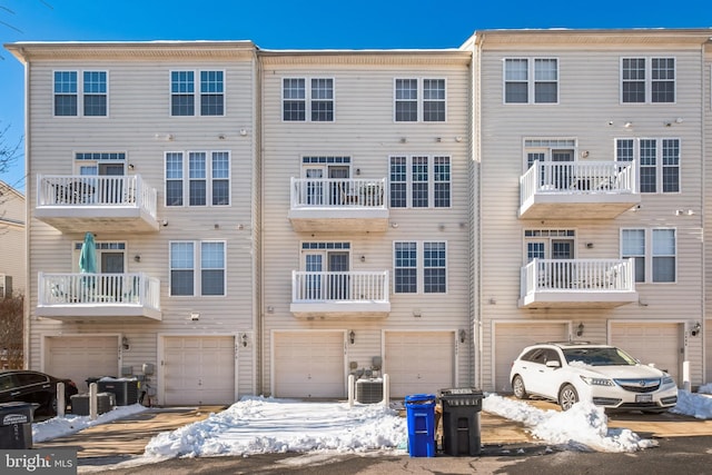 snow covered property with central AC