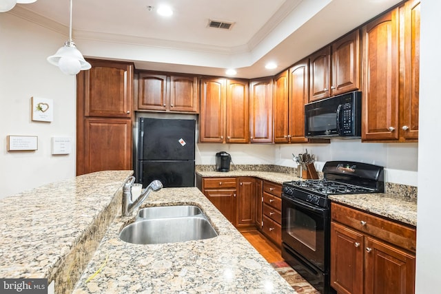 kitchen with sink, decorative light fixtures, light stone countertops, ornamental molding, and black appliances