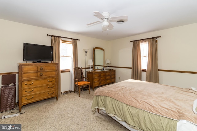 bedroom featuring light carpet and ceiling fan