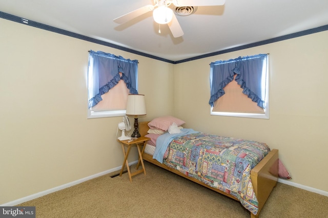 bedroom with multiple windows, ceiling fan, and carpet floors