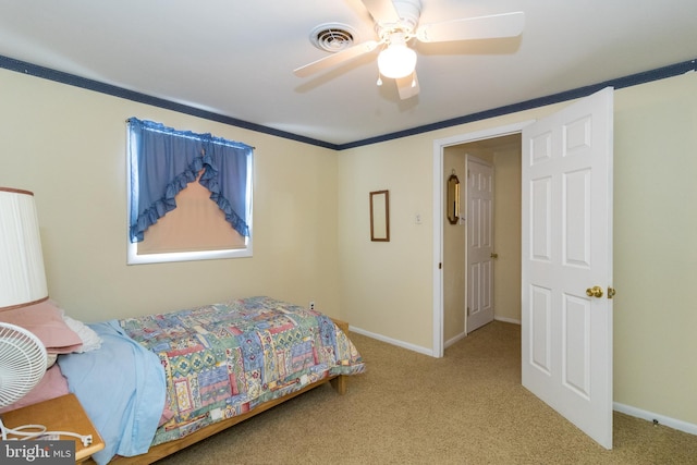 carpeted bedroom featuring ceiling fan and ornamental molding