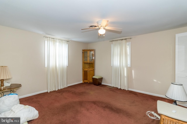 sitting room with carpet flooring, ceiling fan, and a healthy amount of sunlight