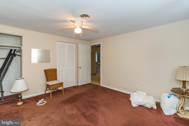 living area with dark colored carpet and ceiling fan