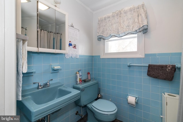 bathroom featuring crown molding, sink, tile walls, and toilet