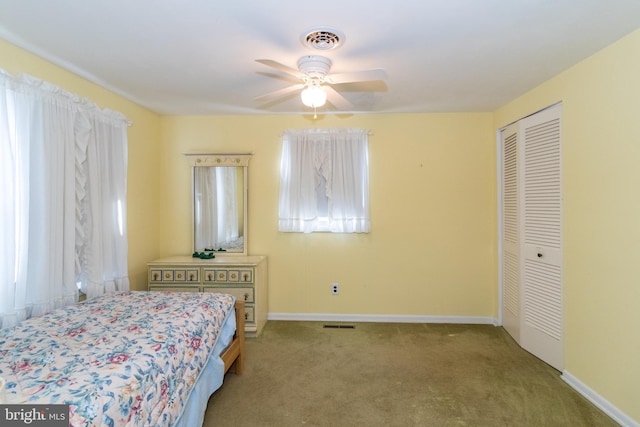 bedroom featuring carpet, ceiling fan, and a closet