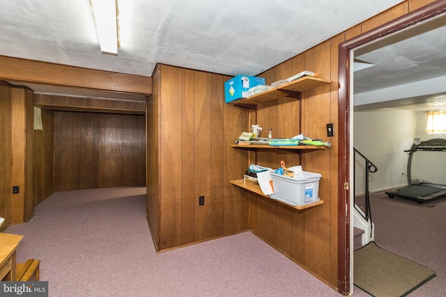 home office featuring wood walls and light carpet