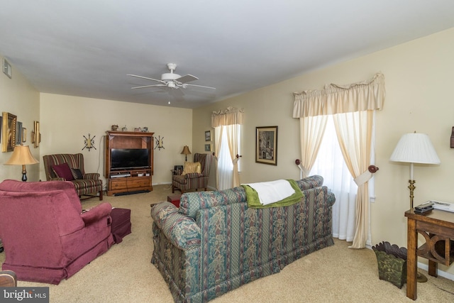 carpeted living room with ceiling fan