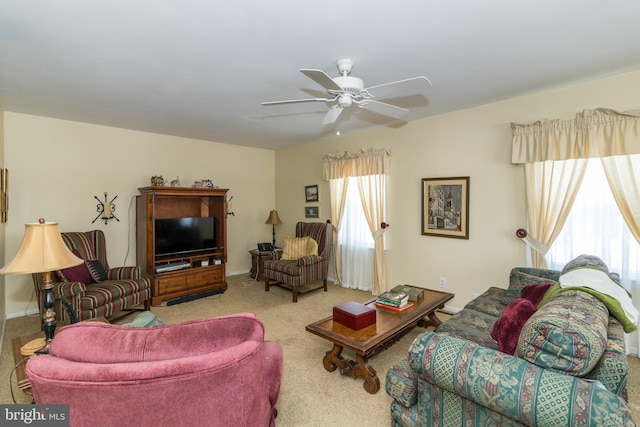 living room with light carpet, plenty of natural light, and ceiling fan