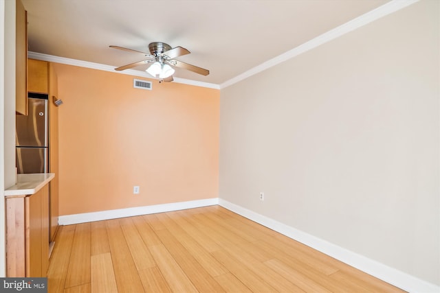 unfurnished room featuring ceiling fan, ornamental molding, and light hardwood / wood-style floors