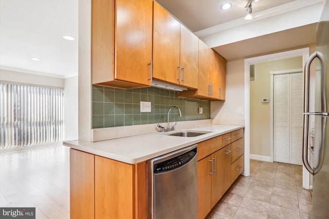 kitchen featuring stainless steel appliances, sink, tasteful backsplash, and ornamental molding