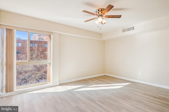 spare room featuring ceiling fan and light hardwood / wood-style floors