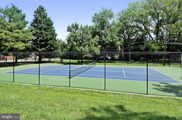 view of sport court with a yard