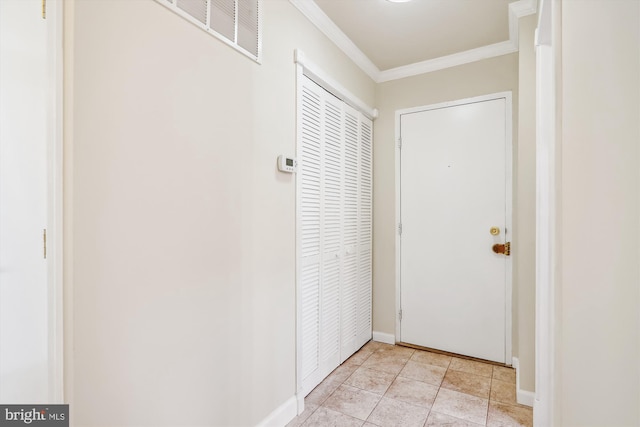 doorway to outside with ornamental molding and light tile patterned floors