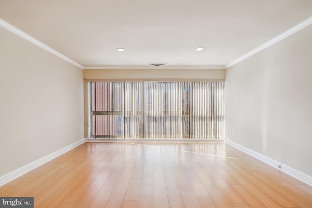 unfurnished room featuring ornamental molding and hardwood / wood-style flooring