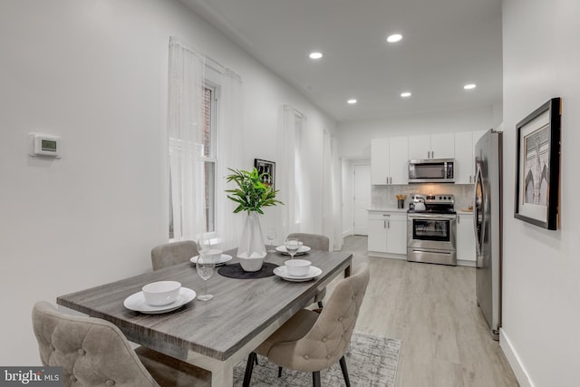 dining space with light wood-type flooring