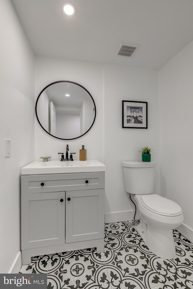 bathroom featuring toilet, vanity, and tile patterned floors