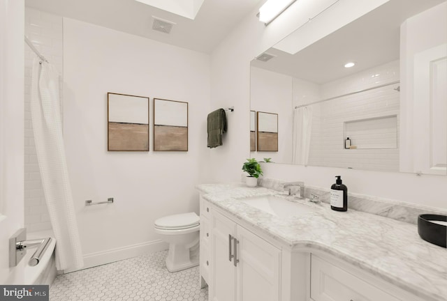 bathroom featuring tile patterned floors, vanity, and toilet