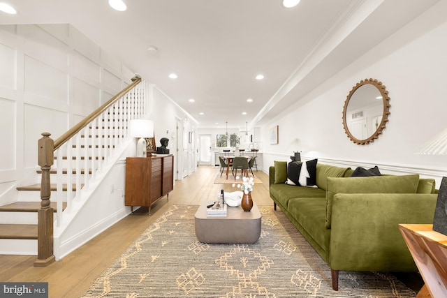 living room with hardwood / wood-style flooring and crown molding