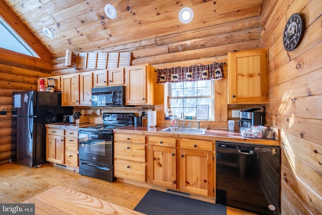 kitchen featuring black appliances, rustic walls, light wood-type flooring, sink, and lofted ceiling