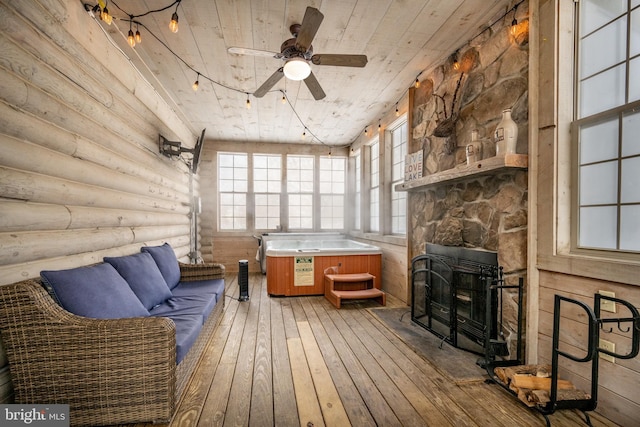 interior space with wood ceiling and ceiling fan