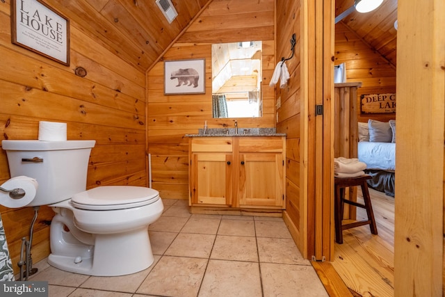 bathroom with wooden ceiling, wooden walls, tile patterned flooring, and vaulted ceiling