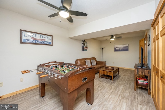 recreation room featuring light hardwood / wood-style floors and ceiling fan