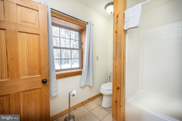 bathroom with toilet, tile patterned floors, and a bathing tub