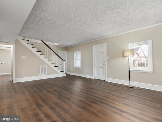 interior space featuring a healthy amount of sunlight, dark hardwood / wood-style floors, and ornamental molding