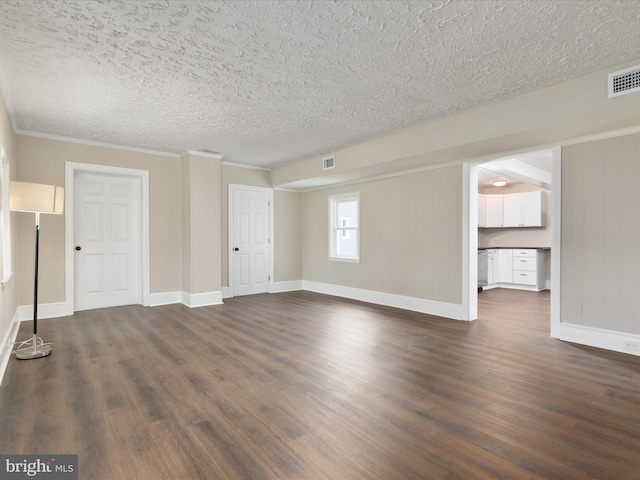 spare room with ornamental molding, dark hardwood / wood-style floors, and a textured ceiling